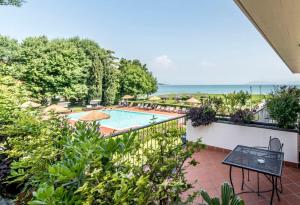 a view of a swimming pool from the balcony of a house at Yachting Hotel Mistral in Sirmione