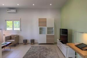 a living room with a couch and a table at Villa Adam in Chania Town