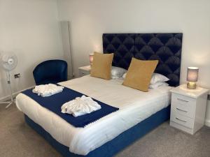 a bedroom with a bed with two towels on it at Allerdale in Torquay