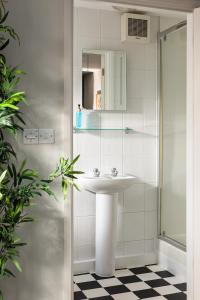 a white bathroom with a sink and a shower at Brayford House in Lincoln