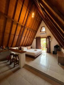 a bedroom with a bed and a desk in a attic at Jepun homestay in Bumbang