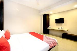 a hotel room with a bed and a tv at OYO Hotel Karma in Jalandhar