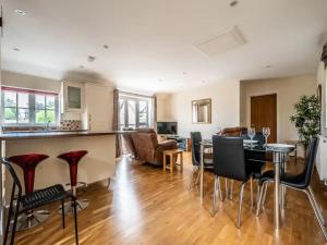 a kitchen and living room with a table and chairs at Spacious modern home in picturesque village in Exeter