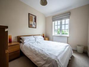 a bedroom with a large bed and a window at Spacious modern home in picturesque village in Exeter