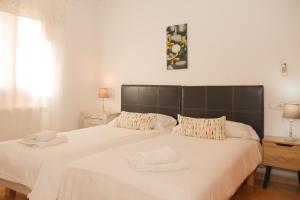 a bedroom with a large bed with two towels on it at 041 Finca Can Roig Gran ET0309 by Mallorca Charme in Pollença +26 photos