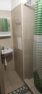 a bathroom with a shower and a sink at Penzión Enbra in Orlov
