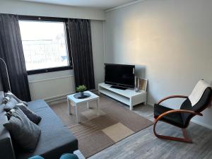 a living room with a couch and a flat screen tv at Style 2BR appartment in Tornio city in Tornio