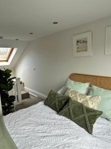 a bedroom with a bed with pillows on it at Gorgeous 1 bedroom & private ensuite in Central Windsor home with FREE PARKING in Windsor