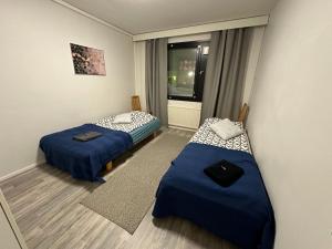 a room with two beds and a window at Style 2BR appartment in Tornio city in Tornio