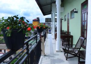 a balcony with potted plants on a building at Grand View Guest House in Haputale