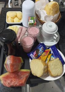 a tray with different types of food on a table at Hotel New Space in Sao Paulo