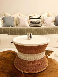 a wicker table in a living room with a couch at Ferienwohnung Darosa Gipfelglück in Seeg