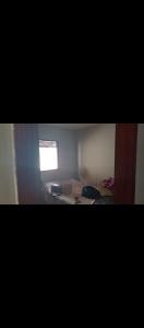a small room with a bed and a window at Casa em Cajupiranga temporada in Parnamirim