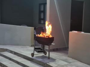 a fire pit with flames in it in a room at Umkhaya Lodge in Mkuze