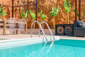 a swimming pool with speakers on the side of a house at Villa Meli in Hersonissos