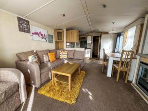 a living room with a couch and a table at Lovely Caravan At Manor Park, Nearby Hunstanton Beach In Norfolk Ref 23067s in Hunstanton