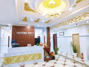 a hotel lobby with a reception desk and a chandelier at Phuong Thuy Hotel in Can Tho