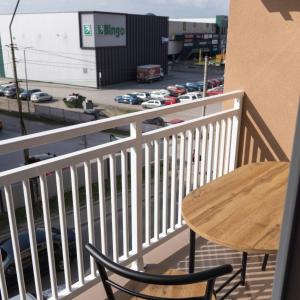 a table and chairs on a balcony with a parking lot at ZARA Apartman Živinice in Živinice