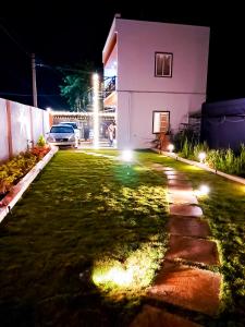 une maison éclairée la nuit dans la cour dans l'établissement Private Paradise Opposite Nandi Hills, à Bangalore