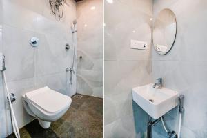 a bathroom with a toilet and a sink and a mirror at FabExpress Ashoka Inn in Mumbai