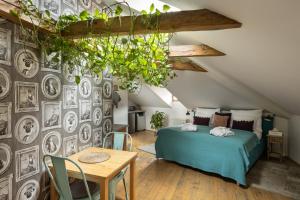 a bedroom with a bed and a wall with pictures at Bohemian Chic 2 Bedroom 2 Bathroom Loft with Hanging Chair in Prague