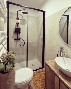a bathroom with a shower and a toilet and a sink at Maison Frida • Tivoli in Tivoli +17 photos