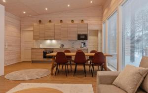 a kitchen and dining room with a table and chairs at Villa Paadari in Inari