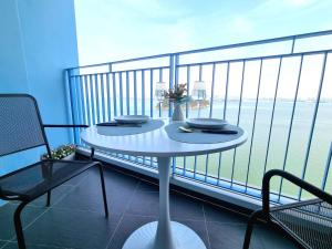 a white table on a balcony with a view of the ocean at Ocean Sole View Hotel in Incheon