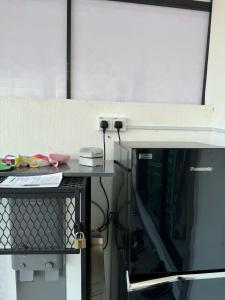 a microwave sitting on top of a counter next to at 15 min to Qing Xin Ling Cultural Village Ipoh in Ipoh