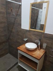 a bathroom with a sink and a mirror at Alma de Puelo in Lago Puelo +61 photos
