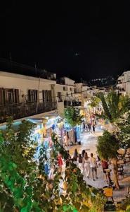 a group of people walking around a market at night at Green Suite Skiathos in Skiathos