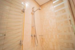 a bathroom with a shower with a glass door at Gardenia Al Fattan Marine Suites - Luxury Apartments in JBR with Full Sea View and only 2m walk to Beach in Dubai