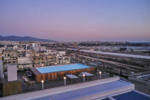 a swimming pool on the roof of a building at CW Athens Riviera Suite in Athens