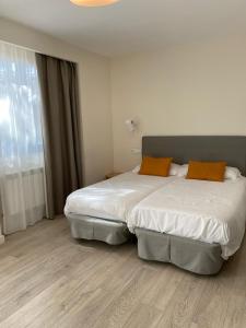 Posteľ alebo postele v izbe v ubytovaní Villa Lucerna Sports & Hotel Resort