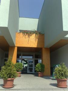 a building with potted plants in front of it at Sport Hotel Ticha Orlice in Ústí nad Orlicí