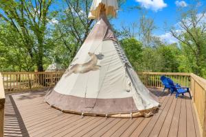 a cat is playing in a teepee on a deck at Furnished Teepee/Glamping/Red River Access/King Bd in Stanton