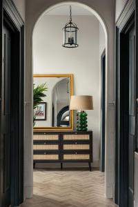 a hallway with a dresser and a mirror at Brayford House in Lincoln