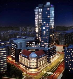 a large building with lights on in a city at night at Hanza Tower Hotel 5 Stars in Szczecin