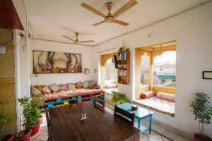 a living room with a couch and a table at The Wanderlust Guest House & Safari in Jaisalmer