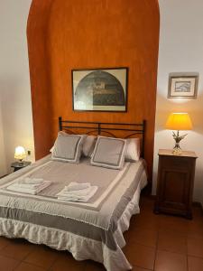 a bedroom with a bed with a large orange wall at Appartamento Duomo in Florence
