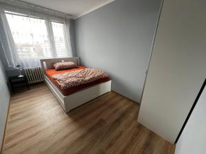 a small bedroom with a bed and a window at Hoa Stay in Prague