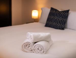 a pile of towels sitting on top of a bed at Oasis studio in the Heart of the City in Brighton & Hove
