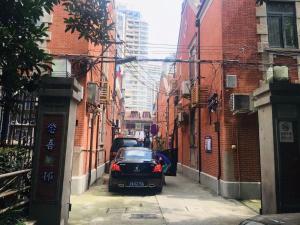 a car parked on a street in an alley at Hills&MING B&B in Shanghai