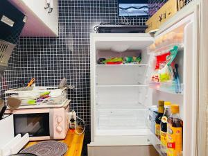 a refrigerator with its door open and a microwave at Hills&MING B&B in Shanghai