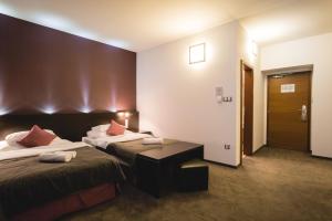 A bed or beds in a room at Hotel Turiec