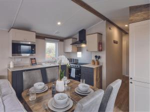 a kitchen and dining room with a table and chairs at Seaton Estate in Arbroath