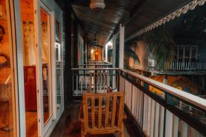 a porch with a rocking chair on a house at OZIBA BEACH RESORT in Arambol