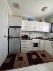 a kitchen with white cabinets and a refrigerator at Delta sharm in Sharm El Sheikh