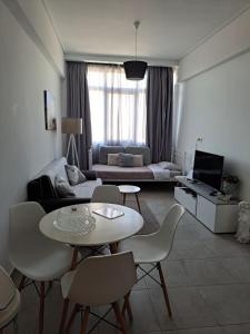 salon z kanapą, stołem i krzesłami w obiekcie Attalos luxury flat Psyrri square w Atenach