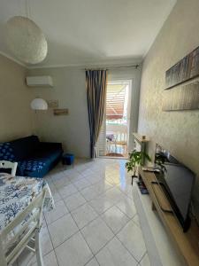 a living room with a couch and a table at Appartamento piscina&mare in Lido di Ostia +51 photos